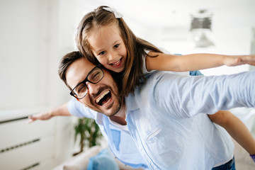 Portrait of father and daughter playing at home
