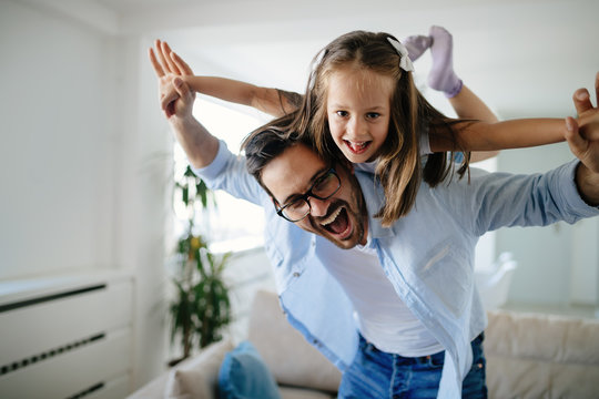 Portrait of father and daughter playing at home