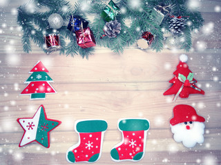 christmas decoration and snow on wooden background