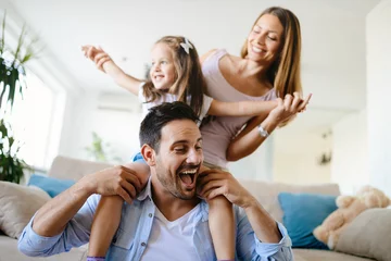 Fotobehang Happy family having fun times at home © NDABCREATIVITY
