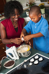 Family: Boy Adds Egg To Mixing Bowl