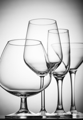 A variety of empty glasses for alcoholic beverages.