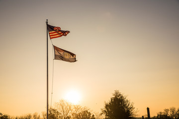 Obraz na płótnie Canvas American and Missouri flags at sunrise
