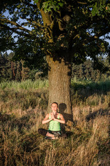Beautiful woman practicing yoga after fitness