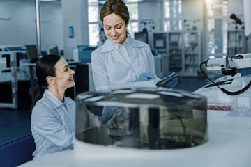 Ready to start. Cheerful happy delighted scientist smiling and being a ready to start while performing a test