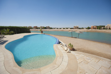 Swimming pool at at luxury tropical holiday villa with beach