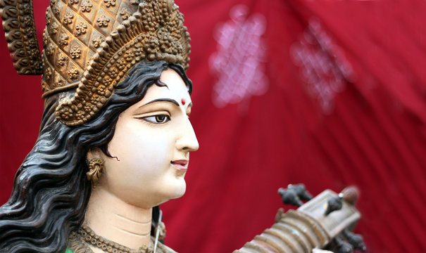Closeup of Idol of Hindu Goddess Swaraswati with stringed musical instrument Veena as in mythology