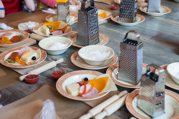 Set of kitchen stainless tools and ingredients for cook for many people on wooden background. Concept preparation for cooking master class