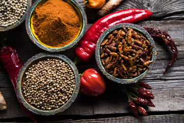 Assortment of spices in wooden bowl background 