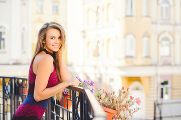 Beauty Glamor Woman smiling looking with interest. He laughs. Long hair. Fashionable lady with a beautiful hairdo, makeup. on the background of the city. fashionable dress