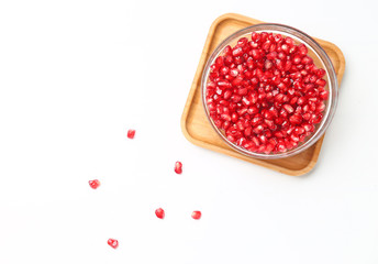 pomegranate seeds in glass bowl isolated on white background