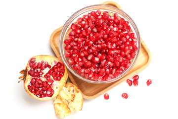 pomegranate seeds in glass bowl isolated on white background