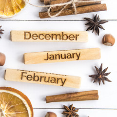 winter still life with the inscriptions of the names of the months - December, January, February among the Christmas products and ornaments. Flat lay