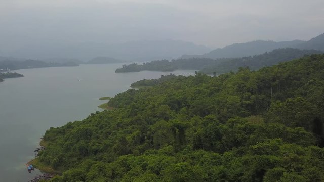 Aerial shot of tropical lake amon jungle lush green islands, rainy weather