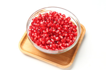 pomegranate seeds in glass bowl isolated on white background