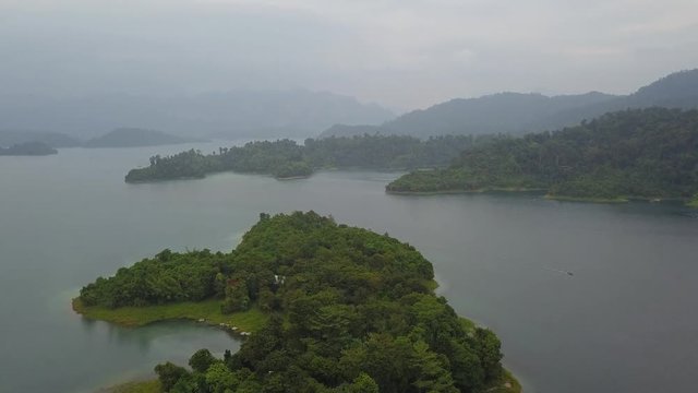 Aerial shot of tropical lake amon jungle lush green islands, rainy weather
