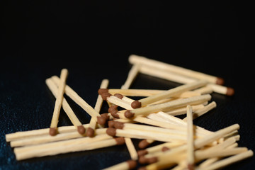 Scattered matches on dark background close up
