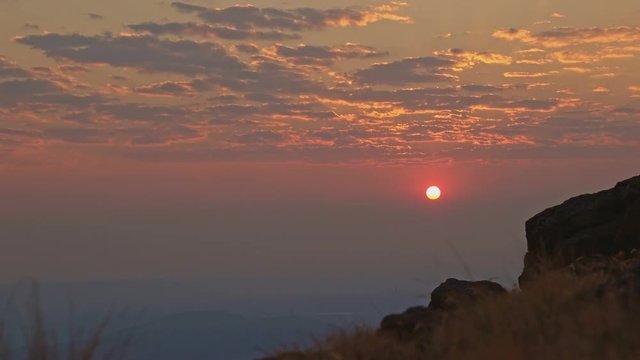 Sunrise red sun peeking through clouds over Alvord Desert from summit of Steens Mountain 2