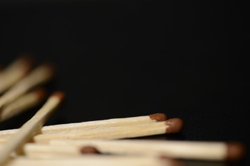 Scattered matches on dark background close up