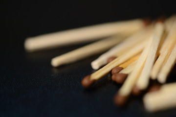 Scattered matches on dark background close up
