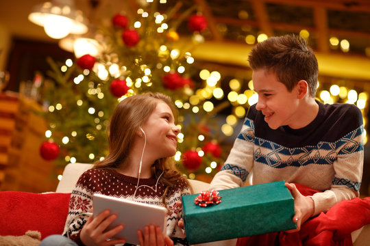 Older Brother Surprise With Present His Little Sister On Christmas .