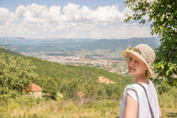 Beautiful young woman with the hat in nature