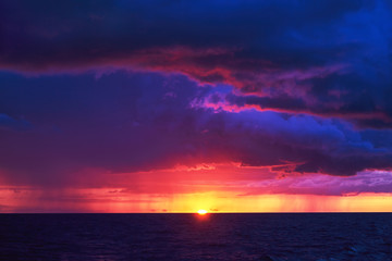 Fototapeta na wymiar Natural Purple Color Sunset Or Sunrise Sky Over Stormy Rainy Sea