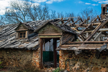 An old abandoned ruined wooden building. Broken doorway