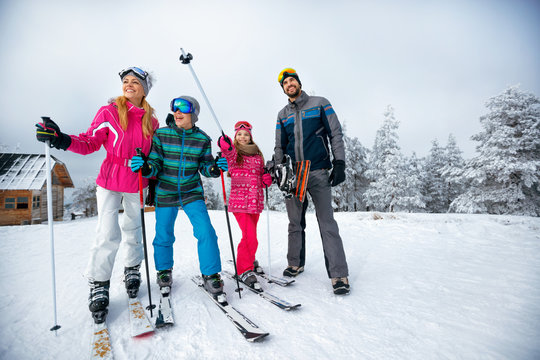winter time and skiing - family with ski and snowboard on ski have fun