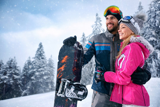love smiling couple enjoying on winter vacation together on the mountain