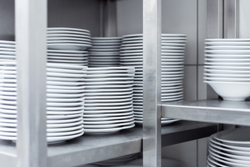 Plates on shelf in restaurant kitchen © qunamax