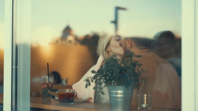 Kissing couple in a cafe