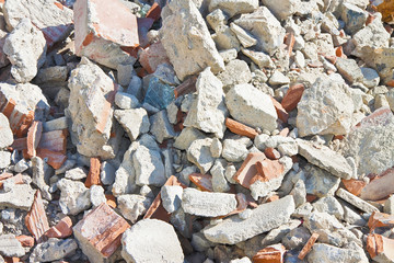 Concrete and brick rubble debris on construction site after a demolition of a brick building
