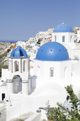 Churches with blue domes in Oia town on Santorini island, Greece