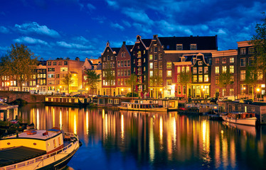 Fototapeta na wymiar Evening town Amsterdam in Netherlands on bank river canal Amstel