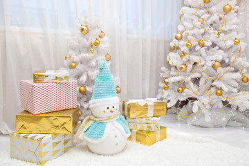 Fototapeta na wymiar New Year white interior with gifts and a snowman
