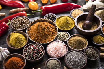 Herbs and spices on a wooden background 