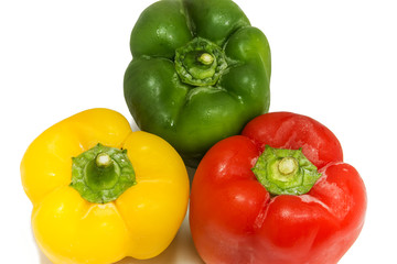 Yellow, green and red peppers isolated on white background