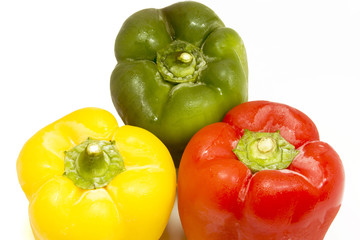 Yellow, green and red peppers isolated on white background