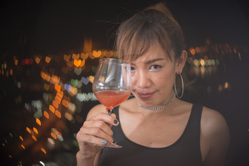 Happy asian woman with red cocktail