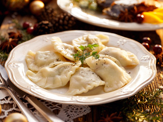 Christmas dumplings stuffed with mushroom and cabbage on a white plate. Traditional Cristmas eve...