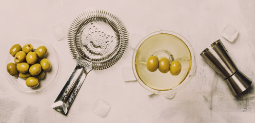 Dry martini cocktail with green olives, toned image, banner, top view