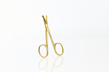 Close up set of gold scissors on black background 