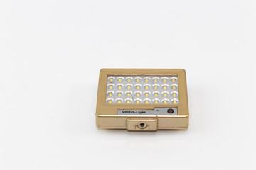 The small LED light in gold box with black stand leg