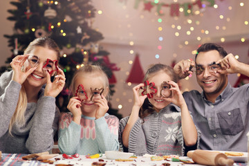 Joyful family preparing Christmas biscuits