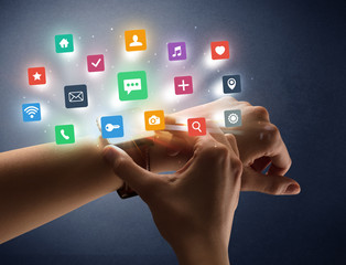 Female hand wearing smartwatch with app icons