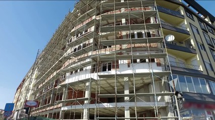 The building under construction with the scaffolind at the construction site