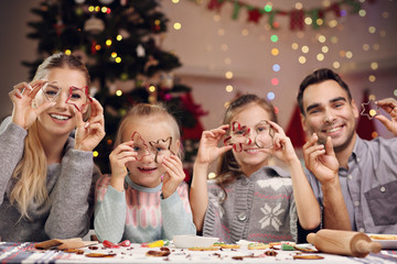 Joyful family preparing Christmas biscuits