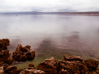 calm sea level, translucent water, rocks