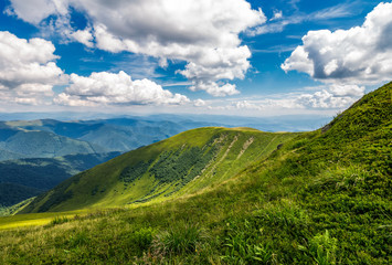 grassy slopes under the beautiful cloudscape. gorgeous summer landscape in mountains